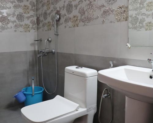 a bathroom with a shower and a toilet and a sink at The Tree Lounge in Bhīm Tāl