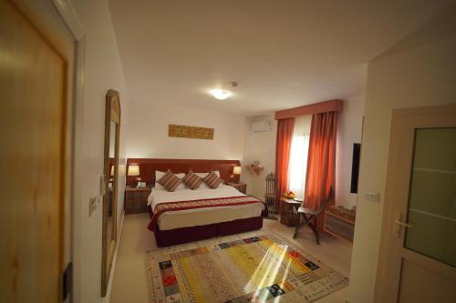 a hotel room with a bed and a window at Petra Plaza Hotel in Wadi Musa
