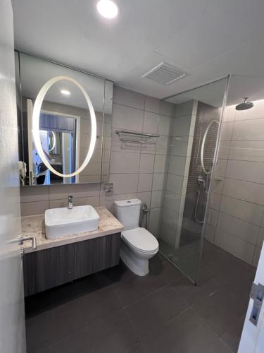 a bathroom with a toilet and a sink and a mirror at Grand Ion Delemen by 91 Homestay in Genting Highlands