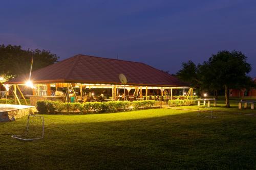 a building with lights in a yard at night at Mekandi Riverside Resort in Akuse