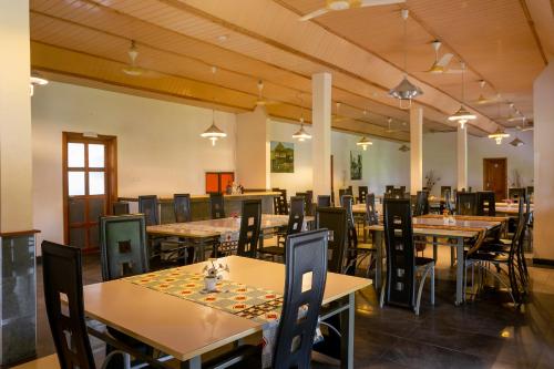 a dining room filled with tables and chairs at Mekandi Riverside Resort in Akuse