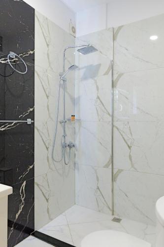 a shower with a glass door in a bathroom at Vila Bana in Qeparo