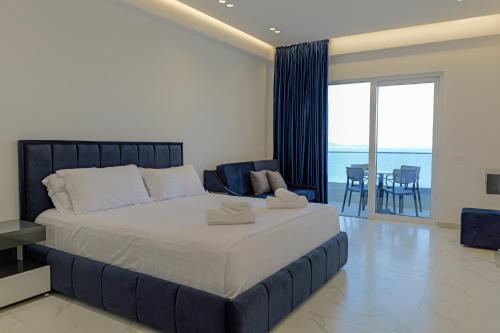 a bedroom with a large bed with a view of the ocean at Vila Bana in Qeparo