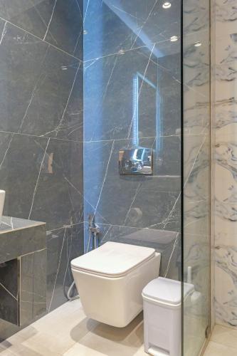 a bathroom with a toilet and a glass shower at Vila Bana in Qeparo