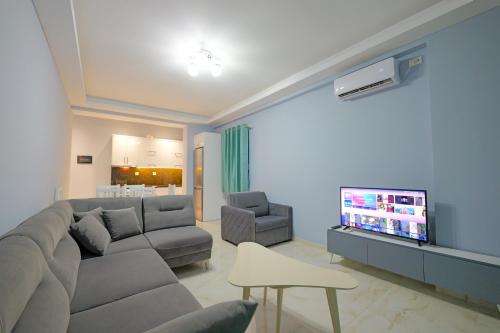 a living room with a couch and a flat screen tv at Vila Bana in Qeparo