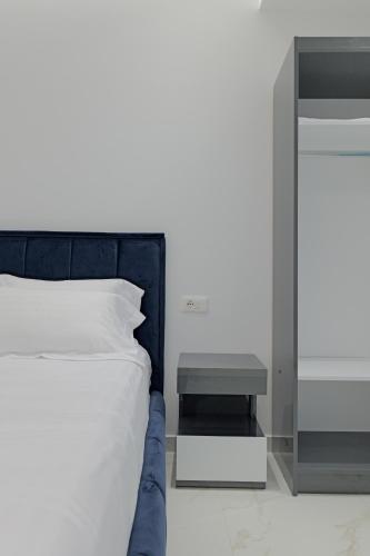a bedroom with a bed and a side table at Vila Bana in Qeparo