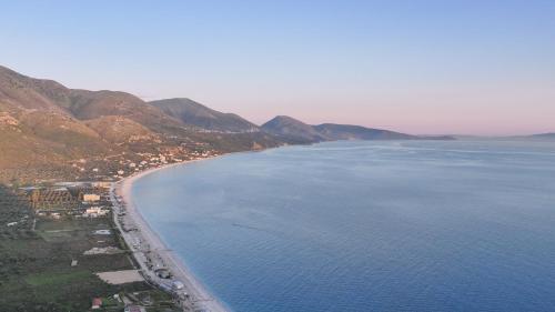 an aerial view of a beach with mountains at Vila Bana in Qeparo
