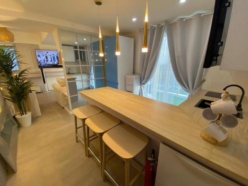 a kitchen and living room with a counter and chairs at Muji Inspired Beach view in San Fernando