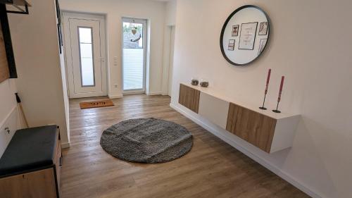 a hallway with a mirror on the wall and a rug at Ferienhaus-Annelore in Lathen