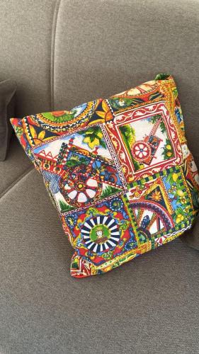 a colorful pillow sitting on top of a couch at ! 1 min dalla Sagra della Salsiccia in Santa Ninfa