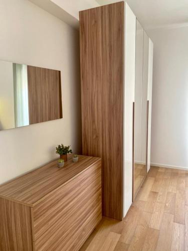 a room with a wooden cabinet and a mirror at ! 1 min dalla Sagra della Salsiccia in Santa Ninfa