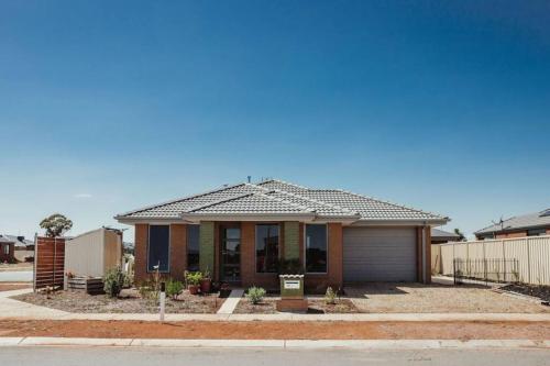 a small house with a roof on a street at Shepparton Family Haven Spacious Retreat in Shepparton