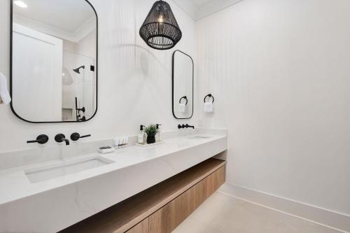 a bathroom with two sinks and a mirror at Somewhere With You in Inlet Beach