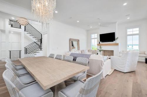 a dining room with a table and chairs at Somewhere With You in Inlet Beach
