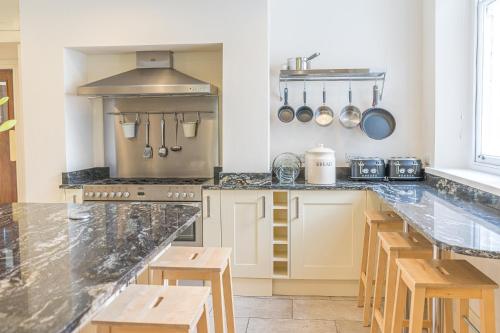 a kitchen with a counter and a stove top oven at Thwaite Howe in Keswick