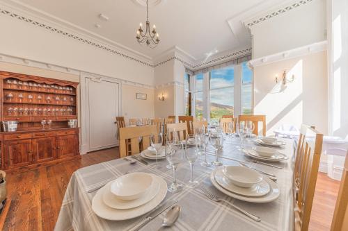 a dining room with a table with plates and silverware at Thwaite Howe in Keswick
