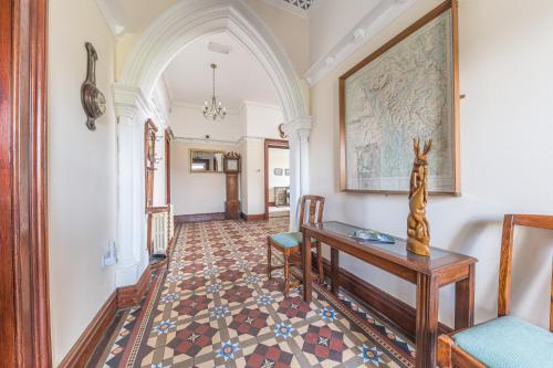 a hallway with a table and chairs and an archway at Thwaite Howe in Keswick
