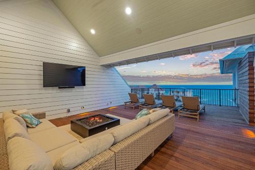 a living room with a couch and a flat screen tv at Somewhere With You in Inlet Beach
