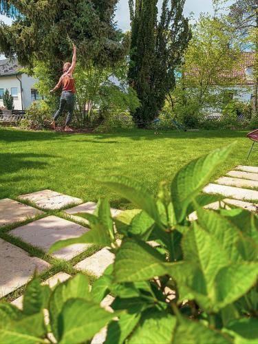 a person throwing a frisbee in a park at Hacienda Rooms in Friedrichshafen