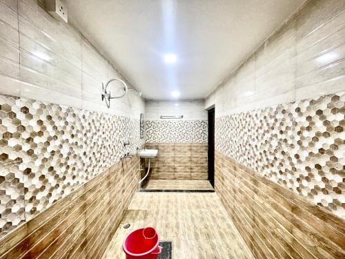 a walk in shower with wooden floors and walls at Hotel DEV VILLA GUEST HOUSE ! VARANASI fully-Air-Conditioned hotel at prime location, near Kashi Vishwanath Temple, and Ganga ghat in Varanasi