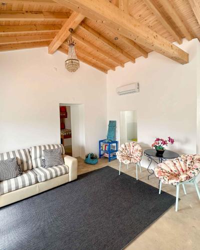 a living room with a couch and chairs and a table at Valle D`Água - Casas de campo in Vale de Água