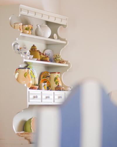 a shelf filled with lots of tea pots and pans at Valle D`Água - Casas de campo in Vale de Água
