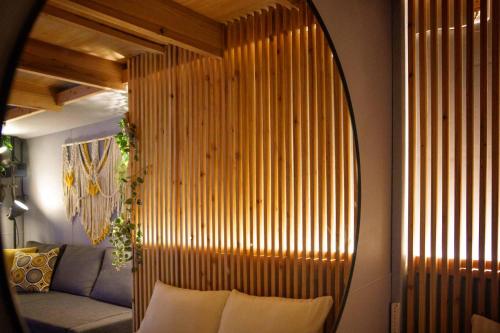a large mirror in a living room with a couch at 日向サーフキャンプ110 in Hyuga