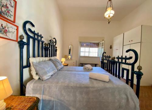 a bedroom with a large bed with a blue bedspread at Villa Marina con 10 posti letto a 350 mt dal mare in Campomarino