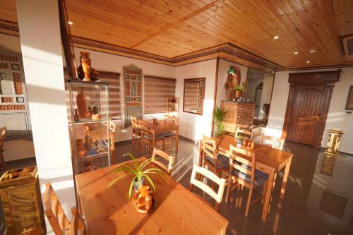 a dining room with wooden tables and chairs at Petra Plaza Hotel in Wadi Musa