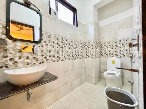 a bathroom with a sink and a toilet at Hotel SHIVAM ! Varanasi Forɘigner's Choice ! fully-Air-Conditioned-hotel lift-and-Parking-availability, near Kashi Vishwanath Temple, and Ganga ghat 2 in Varanasi