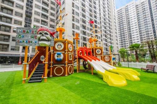 een speeltuin met een glijbaan in het gras bij Homestay Vinhomes Ocean Park in Gia Lâm Pho