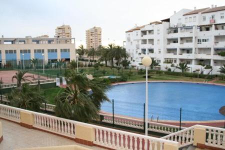a large swimming pool in a city with buildings at Apartamentos Marinesco V.v. in La Manga del Mar Menor