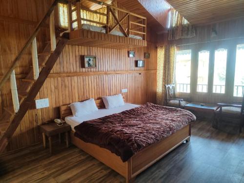 a bedroom with a large bed in a wooden room at Royal Dutch Resorts and Doll Museum in Mukteswar
