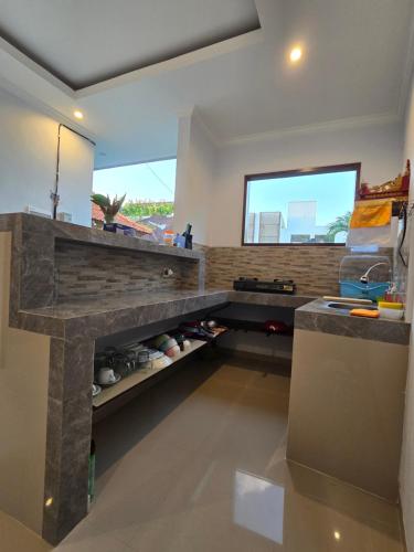 a kitchen with a counter and a counter top at The Lucky Canggu 2 in Canggu