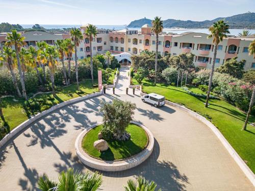 an aerial view of a building with a park at Pullman Almar Timi Ama Resort & Spa in Villasimius