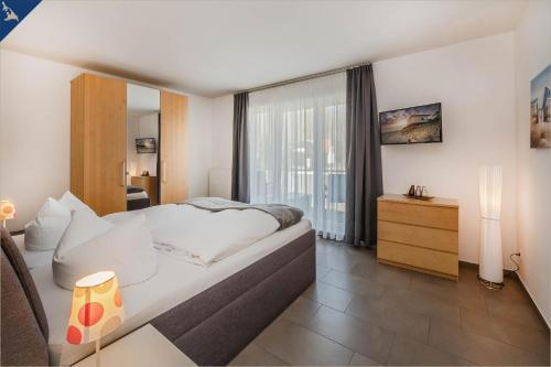 una camera d'albergo con un grande letto e una finestra di Villen am See - Villa Petra Whg Ahlbeck a Korswandt