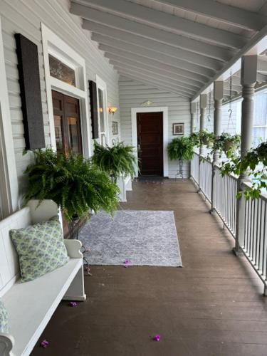 a hallway of a house with potted plants at Woodbine Inn and Restaurant in Madisonville