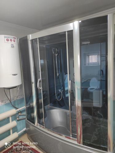 a bathroom with a bath tub in a room at Your House in Karakol