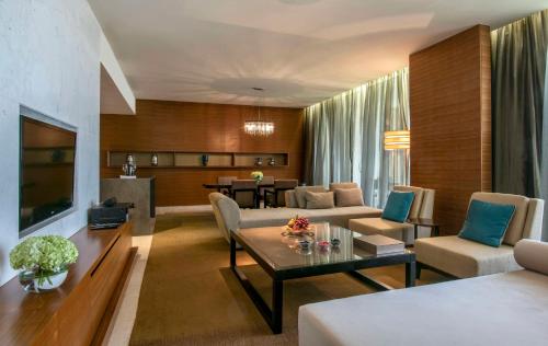 a living room with a couch and a table at Park Hyatt Abu Dhabi Hotel and Villas in Abu Dhabi