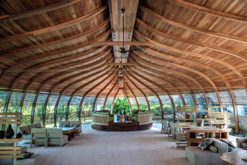 a large room with a large wooden ceiling at Park Hyatt Maldives Hadahaa in Gaafu Alifu Atoll
