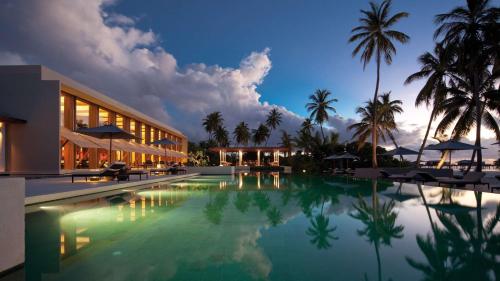 a view of a resort swimming pool at night at Park Hyatt Maldives Hadahaa in Gaafu Alifu Atoll