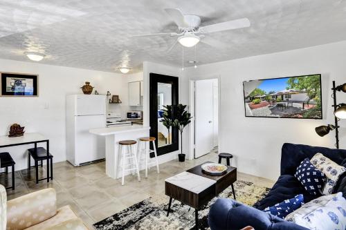 a living room with a couch and a kitchen at Victoria Park Regency in Fort Lauderdale