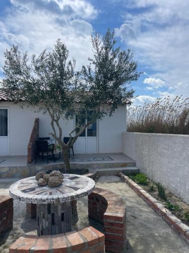 a patio with a table in front of a house at Diarla's Home 4 in Darëzeza e Re