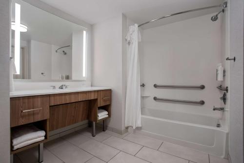 a bathroom with a tub and a sink and a shower at Homewood Suites by Hilton Davidson in Davidson