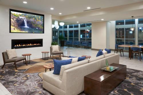 a lobby with a couch and a fireplace at Hilton Garden Inn Philadelphia Center City in Philadelphia