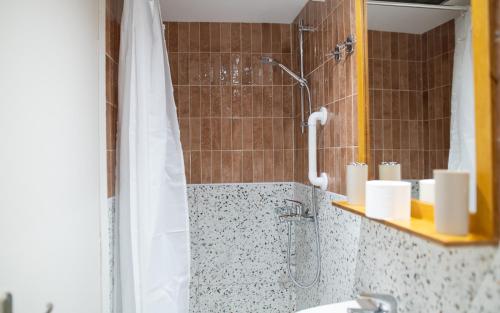 a bathroom with a shower and a sink at Achilleas Hotel Apartments in Kos