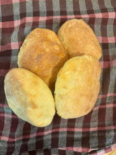 three bread rolls sitting on a table at Qyteza Guest House & Camping in Shkodër