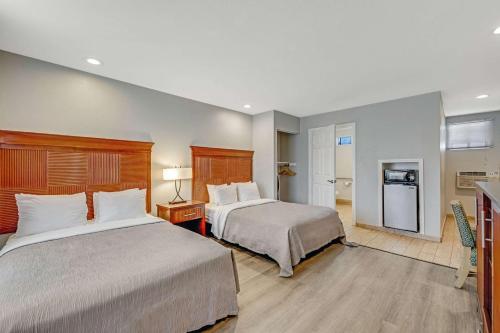 a hotel room with two beds and a kitchen at Quality Inn Santa Cruz Downtown Area in Santa Cruz