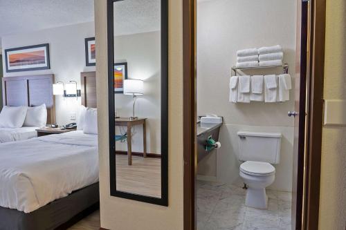 a hotel room with a bed and a toilet at Quality Inn Milan-Sandusky in Milan