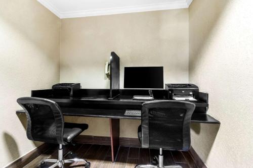 an office with a desk with a computer and two chairs at Comfort Inn Evansville East in Evansville